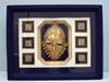 framed mask in center with small square medallions surrounding it
